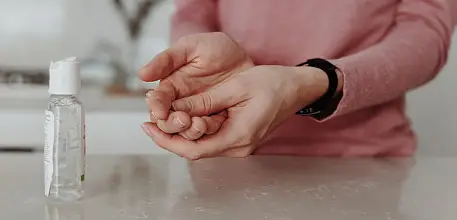 Woman using hand sanitiser