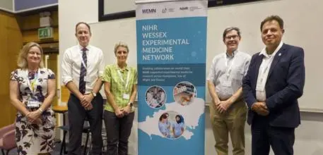 Team standing next to Wessex Experimental Medicine Network pull-up banner 