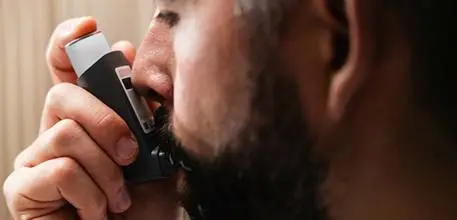 Asthma patient using inhaler