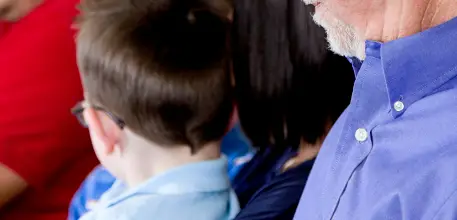 Young boy sat with his parents