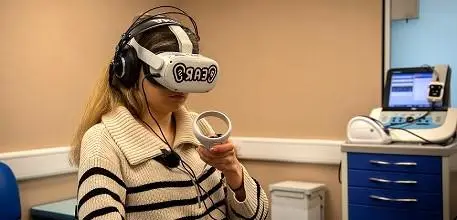 Student Libby Gotta, who has two cochlear implants, trying out the VR software