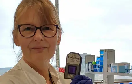 Researcher with chip that contains genetic information about bladder cancer