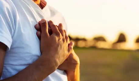 Person with hands on their heart