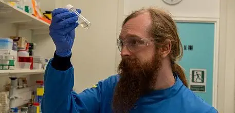 Callum Highmore looking at liquid in a test tube