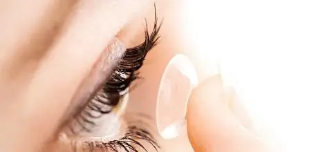 Person putting in contact lense