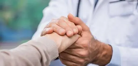 Doctor holding patient's hand