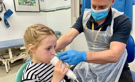Child exhaling with mouth piece
