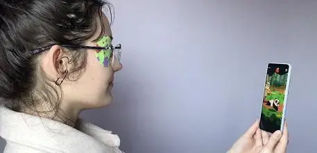 Girl with eye patch playing game on phone