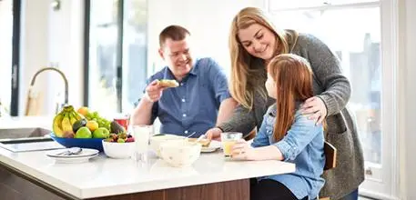A family in the kitchen eating