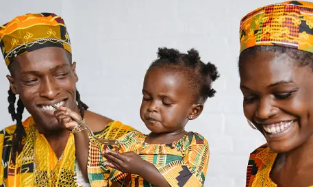 African family with young child eating