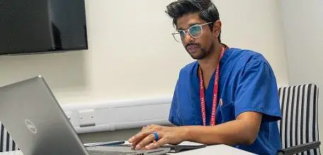 Dr Ganesh Vigneswaran working on a laptop