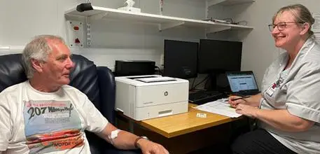 Participant Ian Robinson talking to a research nurse at University Hospital Southampton
