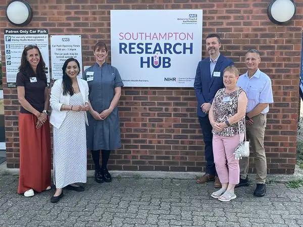 Group of people standing by the new sign