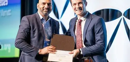 Dr Joseph Larvin being presented with his award 