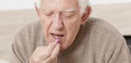 Old man taking medication
