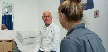 Cancer vaccine trial participant Paul Thomas with a research nurse at UHS