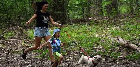 Mum running with boy and dog