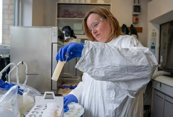 Dr Nat Easton taking out a sample in the laboratory.