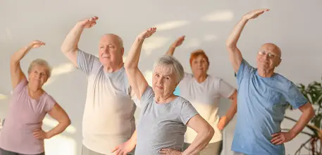 Elderly people in exercise class