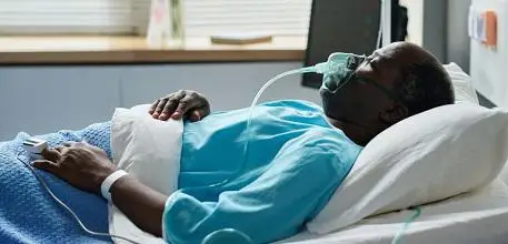 Person with oxygen mask in hospital