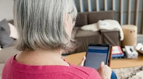 Patient completing questionnaire on tablet