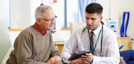 Older man talking to doctor