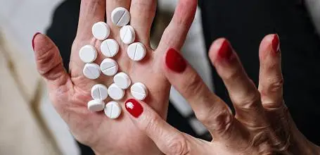 Woman counting pills