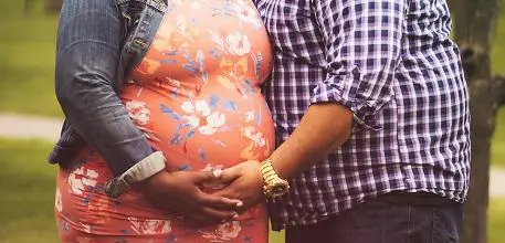 Couple holding baby bump
