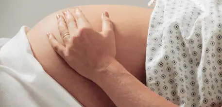 Pregnant woman holding stomach
