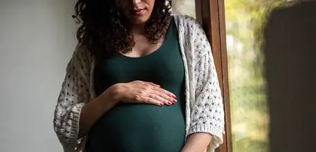 Pregnant woman holding her belly