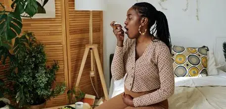 Pregnant woman using inhaler