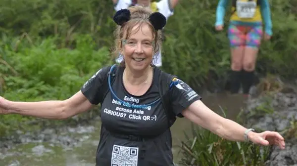 Participant Janie Allen taking part in a 20-mile Grizzly mud and hills race