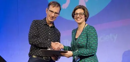 Dr Hannah Schiff being presented with her award