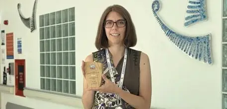 Sofia Michopoulou in a hospital corridor holding her award