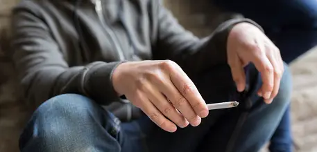 Teenage boy smoking a cigarette