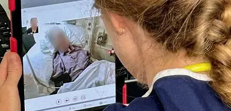 A specialist stroke nurse communicates with paramedics in the ambulance
