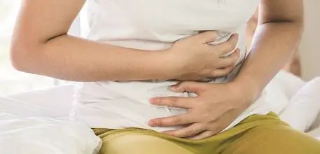 Woman clutching her stomach