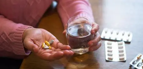 Woman taking multiple different pills